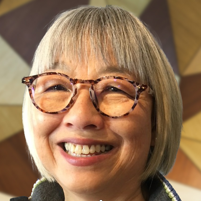 Suzanna So Ha Wong smiles through her glasses, infectiously.