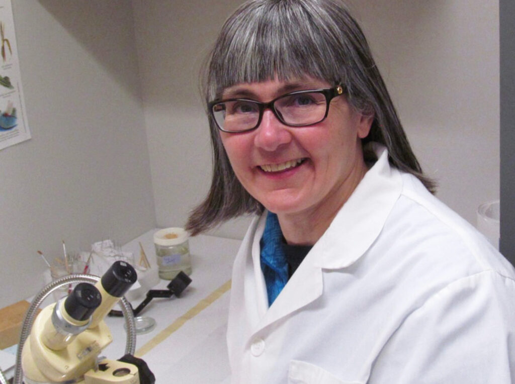 Dr. Janet Sperling, president of the Canadian Lyme Disease Foundation, stands at her microscope.