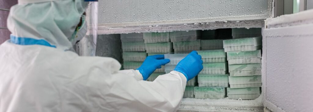 Cutline: A technician removing biological samples from storage in a biobank.